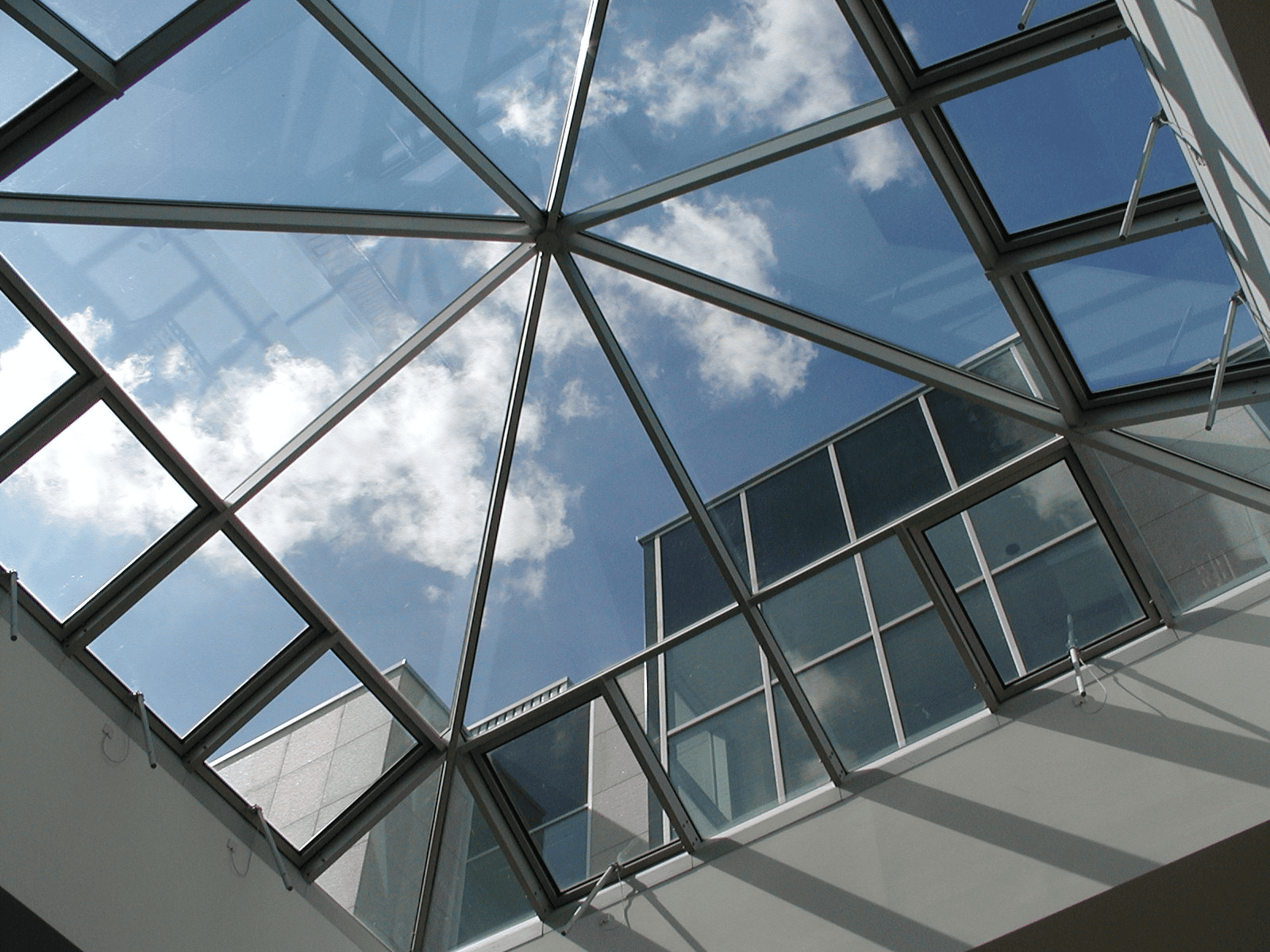 Commercial skylights installation by Horizon Glass located near me, showcasing a bright sky through a glass ceiling.