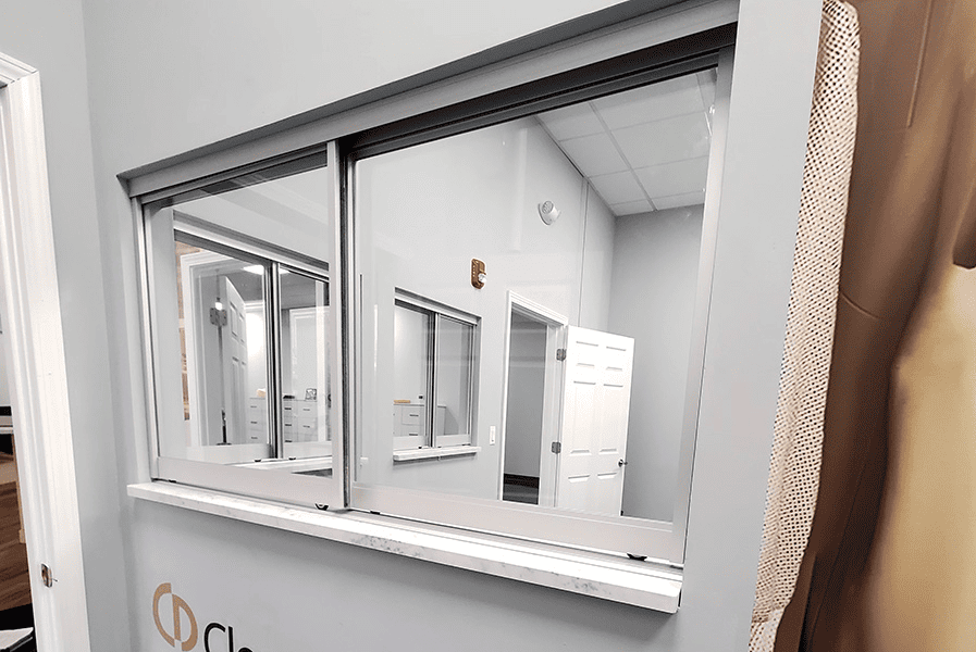 Modern transaction window installation by Horizon Glass near me, showcasing a sleek design in a business setting.