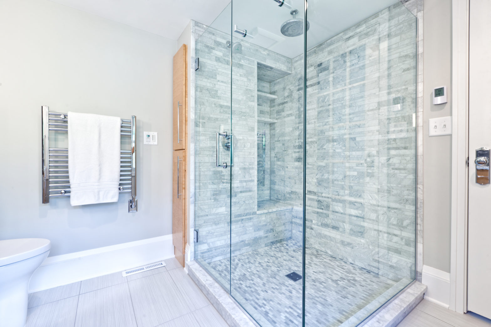 Expert Horizon Glass installer precision-measuring for new shower door in Centennial, CO home