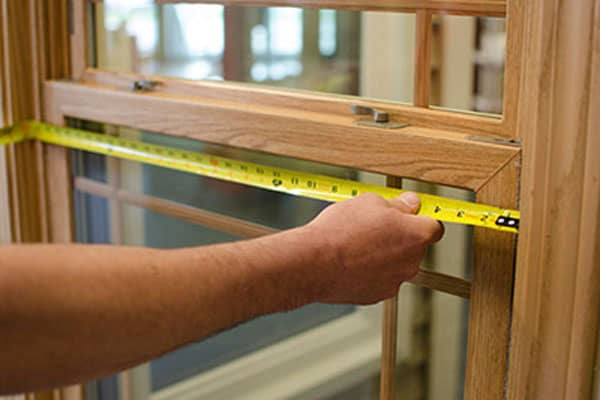 Experienced installer safely fitting modern windows in a high-rise Aurora, CO apartment