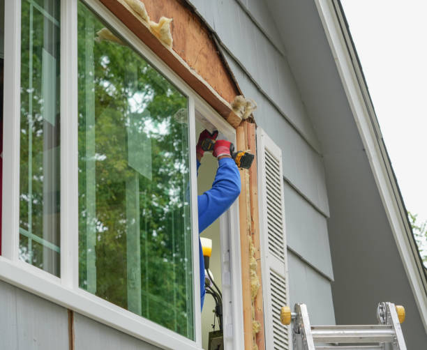 Installer measuring and fitting new window frame in a Centennial, CO suburban home living room
