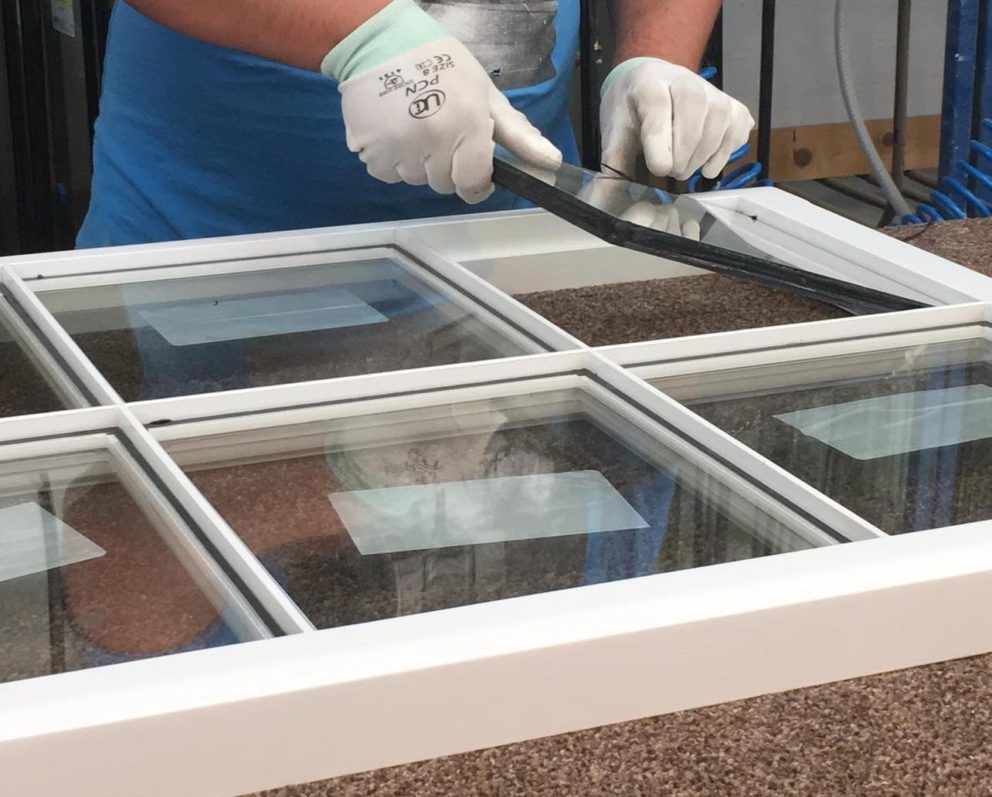 Installer fitting triple-pane window to protect Denver home from cold winter weather